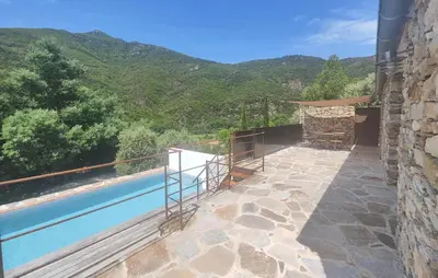 a house with a swimming pool with mountains in the background at 3 Bedroom Stunning Home In Vieussan in Vieussan