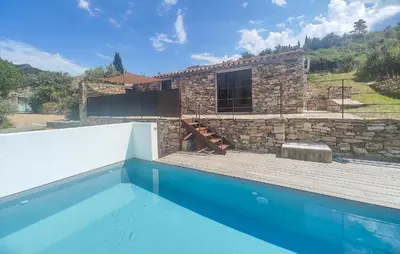 a stone house with a swimming pool in front of it at 3 Bedroom Stunning Home In Vieussan in Vieussan