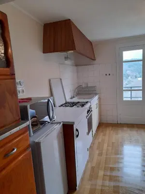 a kitchen with white appliances and a window at Les Citronniers in Belvianes-et-Cavirac