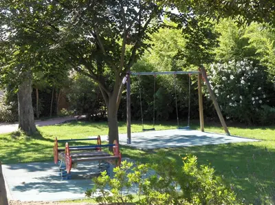a park with a playground with a swing at VVF Sigean Port-la-Nouvelle Corbières in Sigean