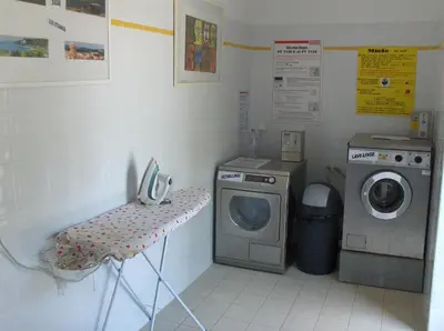 a laundry room with a washing machine and a washer at VVF Sigean Port-la-Nouvelle Corbières in Sigean