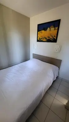 a bunk bed in a room with a blue wall at VVF Sigean Port-la-Nouvelle Corbières in Sigean