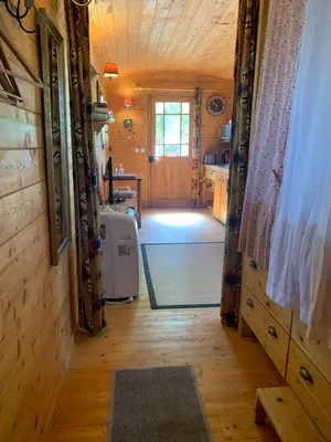a hallway leading to a kitchen in a tiny house at La roulotte de Plajoulet in Mirepoix