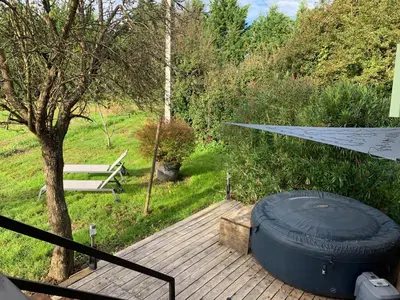 a large tire sitting on top of a wooden deck at La roulotte de Plajoulet in Mirepoix