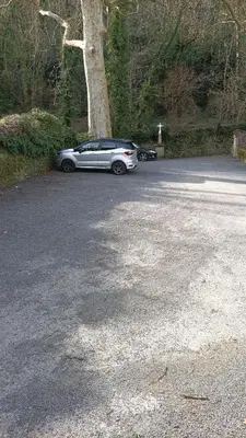 a silver car parked next to a tree at Gite centre village Burlats in Burlats