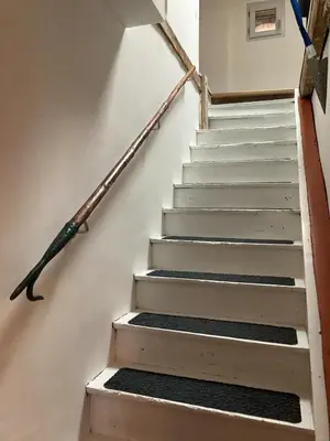 a set of stairs with a handrail and a stair case at Gite centre village Burlats in Burlats