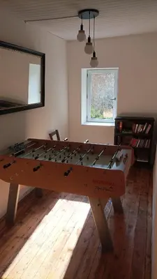 a ping pong table in the middle of a room at Gite centre village Burlats in Burlats