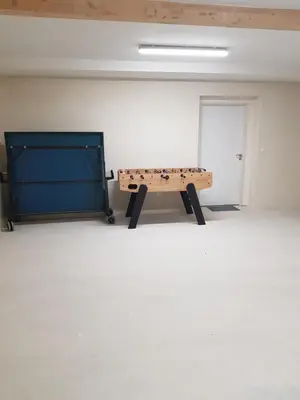 a ping pong table in a room with a door at Maison Stellas in Fontiès-dʼAude