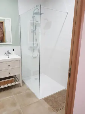 a glass shower in a bathroom with a sink at Maison Stellas in Fontiès-dʼAude