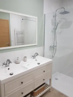 a white bathroom with a sink and a shower at Maison Stellas in Fontiès-dʼAude