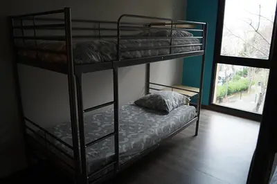 two bunk beds in a room with a window at Centre International de Séjour - MJC in Lézignan-Corbières