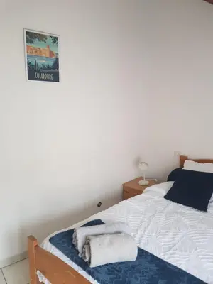 a bedroom with a bed and a sign on the wall at Gîtes Tautavel in Tautavel