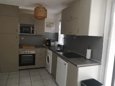 a kitchen with a sink and a dishwasher at Maison avec jardin clos dans residence in Gruissan