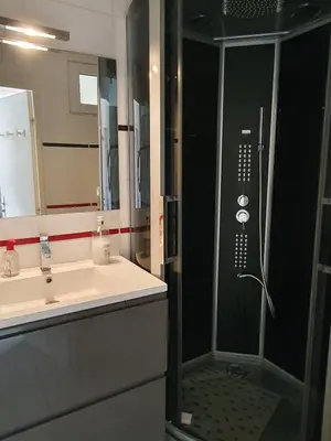 a bathroom with a shower and a sink at Maison avec jardin clos dans residence in Gruissan
