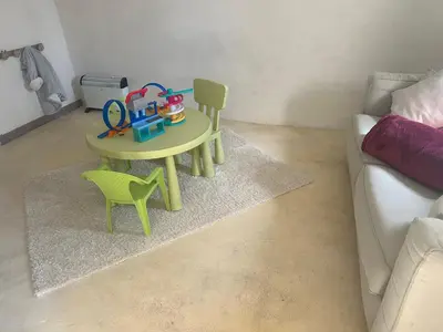 a toy table and chairs in a living room at Ma petite chaumière in Bouilhonnac