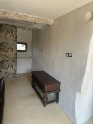 a piano sitting in a room with a wall at Ma petite chaumière in Bouilhonnac