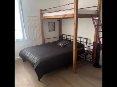a bedroom with a bunk bed and a ladder at Le Rive Gauche - Au cœur du centre historique in Narbonne
