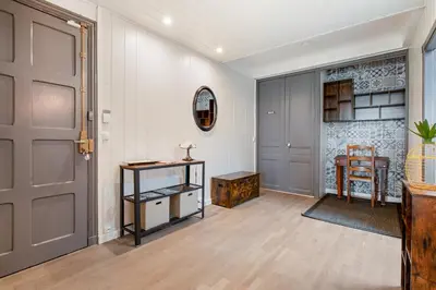 an empty hallway with a door and a table at Le Rive Gauche - Au cœur du centre historique in Narbonne