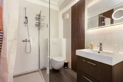 a bathroom with a shower and a toilet and a sink at Le Rive Gauche - Au cœur du centre historique in Narbonne