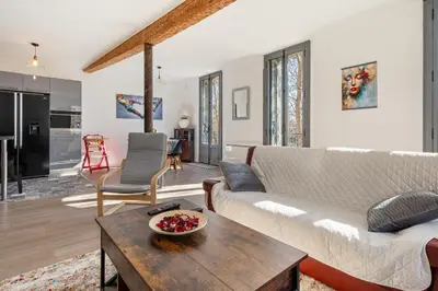 a living room with a couch and a table at Le Rive Gauche - Au cœur du centre historique in Narbonne