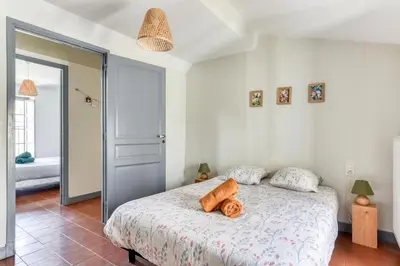 a bedroom with a bed with two logs on it at Cocon Carcassonnais - Free parking - Wifi - Climatisation - Tout équipée in Carcassonne