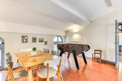 a living room with a ping pong table and a dining room with a pool at Cocon Carcassonnais - Free parking - Wifi - Climatisation - Tout équipée in Carcassonne