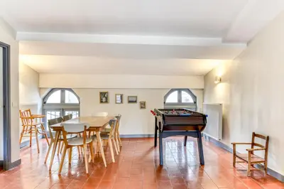 a room with a ping pong table and chairs at Cocon Carcassonnais - Free parking - Wifi - Climatisation - Tout équipée in Carcassonne