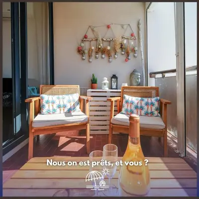 two chairs sitting on a porch with a table at Le Rivage du Nilautom in Gruissan