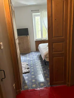 a room with a bedroom with a bed and a window at CHAMBRE D'HOTE Ô MAZETTE visite de l'Aude in Fabrezan