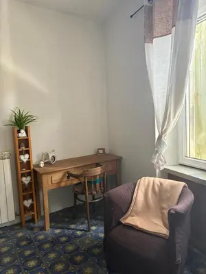 a room with a desk and a chair next to a window at CHAMBRE D'HOTE Ô MAZETTE visite de l'Aude in Fabrezan