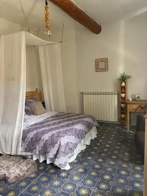 a bedroom with a bed and a couch at CHAMBRE D'HOTE Ô MAZETTE visite de l'Aude in Fabrezan