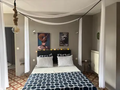 a bedroom with a bed with a black and white checkered blanket at CHAMBRE D'HOTE Ô MAZETTE visite de l'Aude in Fabrezan