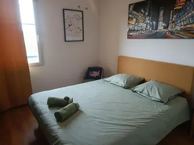 a bed with two pillows on it in a bedroom at Chambre d'hôtes petit déjeuner compris in Carcassonne