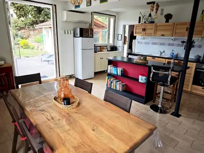 a kitchen with a counter and a bar stool at Terrasse, vue & Parking - Carnaval à pied in Limoux