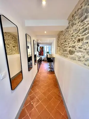 a hallway with a stone wall and mirrors at The62 in Carcassonne