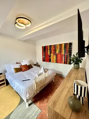 a bedroom with a bed and a wooden table at The62 in Carcassonne