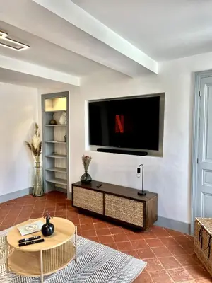a living room with a flat screen tv on a wall at The62 in Carcassonne