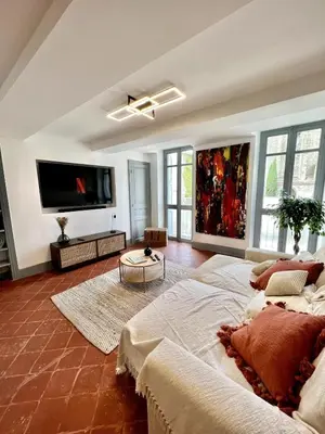 a living room with a large bed and a flat screen tv at The62 in Carcassonne