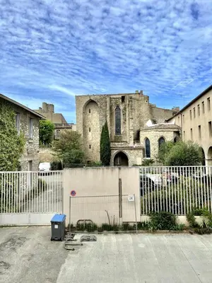 an old building with a fence in front of it at The62 in Carcassonne