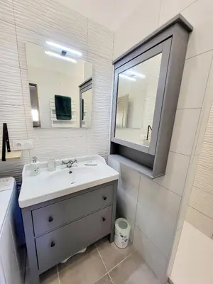a bathroom with a sink and a mirror at Maison au calme - Clim - Wi-Fi - terrasse et cours in Salles-d'Aude