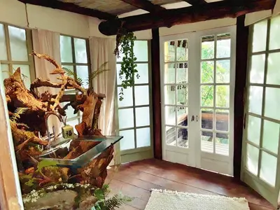 a room with large windows and a glass table at Le Vertige du Tigre in Courniou