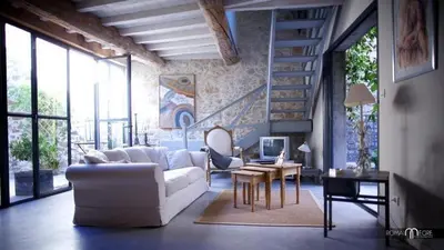 a living room with a white couch and a table at Gîte Brassens in Pouzols-Minervois