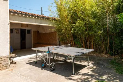 a ping pong table in front of a house at Big House - Parking Privée - Piscine - Wifi - tout équipée in Carcassonne