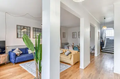 a living room with blue couches and a staircase at Big House - Parking Privée - Piscine - Wifi - tout équipée in Carcassonne