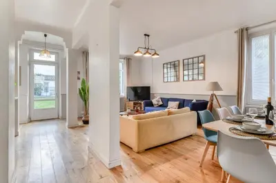 a living room with a couch and a table at Big House - Parking Privée - Piscine - Wifi - tout équipée in Carcassonne