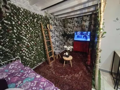 a living room with a couch and a tv at les Lavandes in Saint-Paul-de-Fenouillet