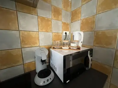 a small kitchen with a toaster and a toaster at Studio de 30 m2 centre-ville NARBONNE in Narbonne
