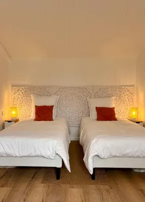 a bedroom with a large bed with two pillows at La Closerie in La Redorte