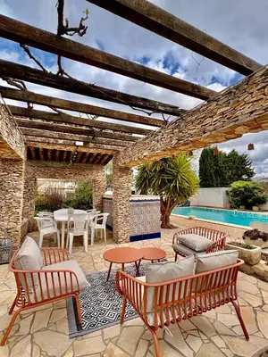 a bedroom with a large bed and a chair at La Closerie in La Redorte