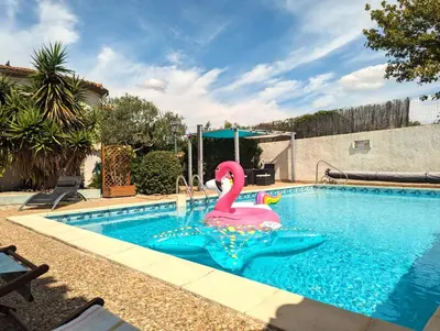 a patio with chairs and tables and a pool at La Closerie in La Redorte